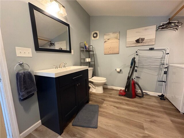 7 E St, Oneonta, NY 13820 - bathroom featuring wood finished floors, vanity, and lofted ceiling