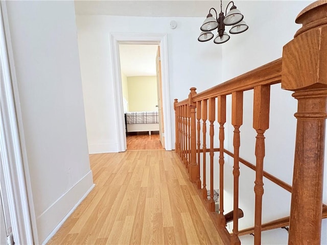 7 E St, Oneonta, NY 13820 - hallway with light wood-type flooring and a chandelier