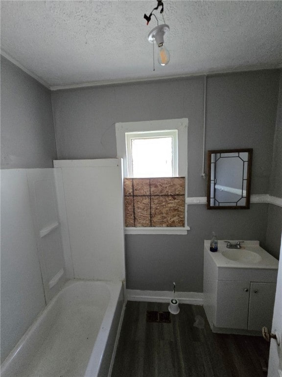 3 Kenmore St, Rochester, NY 14611 - bathroom with wood finished floors, vanity, a bathtub, and a textured ceiling