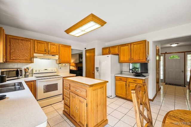 701 Walker Dr, Lewiston, NY 14092 - kitchen with white appliances, under cabinet range hood, light countertops, decorative backsplash, and light tile patterned floors