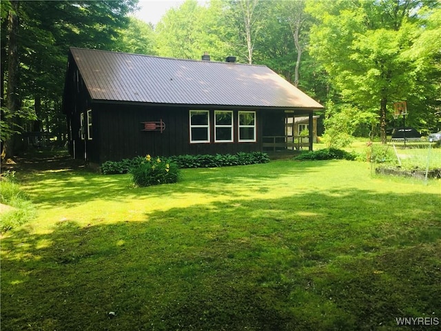 9512 Stillwater Rd, Watson, NY 13367 - back of house featuring a yard, board and batten siding, and a metal roof