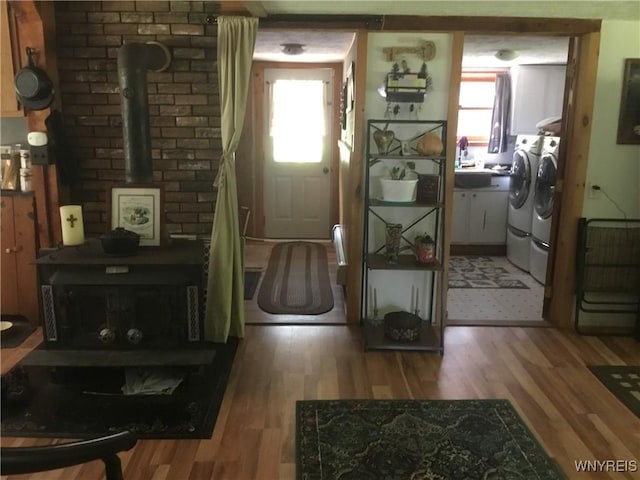 9512 Stillwater Rd, Watson, NY 13367 - foyer featuring a wood stove, light wood-style floors, and independent washer and dryer
