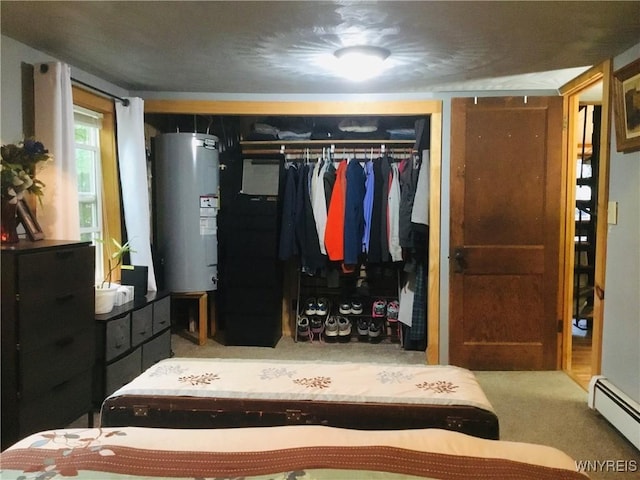 9512 Stillwater Rd, Watson, NY 13367 - carpeted bedroom featuring water heater, a baseboard radiator, and a closet