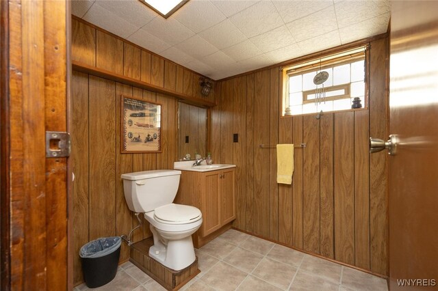 368 Cayuga Creek Rd, Cheektowaga, NY 14227 - half bath featuring wood walls, vanity, and tile patterned flooring