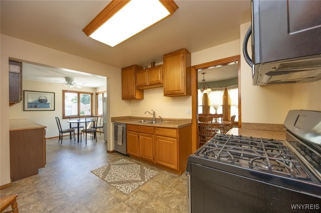 368 Cayuga Creek Rd, Cheektowaga, NY 14227 - kitchen with range with gas cooktop, stainless steel dishwasher, light floors, ceiling fan, and brown cabinetry