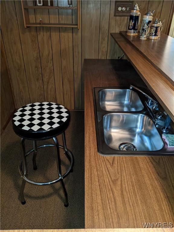 368 Cayuga Creek Rd, Cheektowaga, NY 14227 - bar area with a sink and wood walls