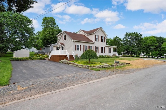 51 State St, Vernon, NY 13421 - view of front facade with a deck, an outbuilding, a front lawn, and asphalt driveway