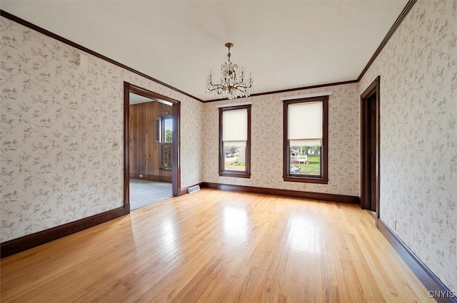 51 State St, Vernon, NY 13421 - empty room featuring crown molding, a chandelier, light wood finished floors, and wallpapered walls