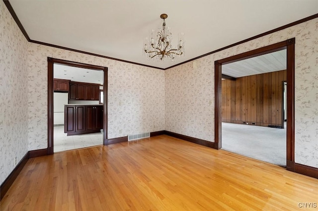 51 State St, Vernon, NY 13421 - unfurnished dining area with a chandelier, light wood finished floors, crown molding, and wallpapered walls