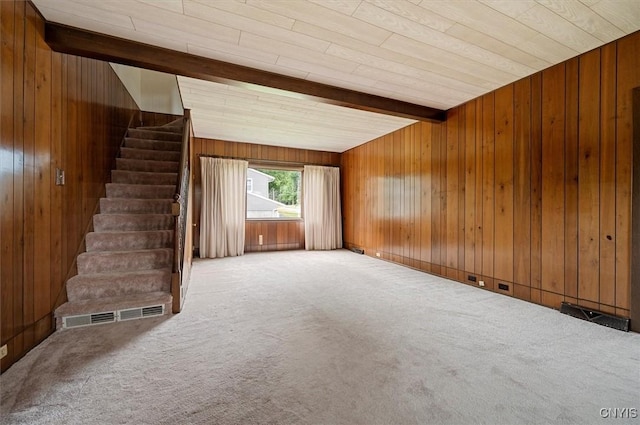 51 State St, Vernon, NY 13421 - unfurnished living room with carpet floors, wooden walls, beamed ceiling, and stairs