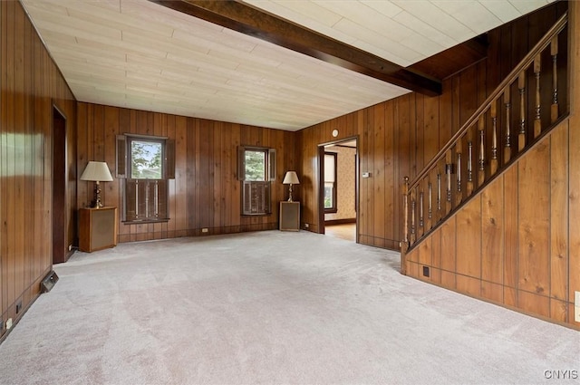 51 State St, Vernon, NY 13421 - unfurnished living room with carpet, stairs, wooden walls, and beam ceiling
