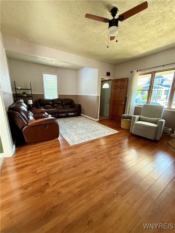 80 Fredro St, Buffalo, NY 14206 - living area with a textured ceiling, wood finished floors, plenty of natural light, and a ceiling fan