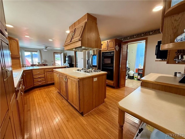 80 Fredro St, Buffalo, NY 14206 - kitchen featuring recessed lighting, light wood-style flooring, light countertops, white gas cooktop, and a kitchen island