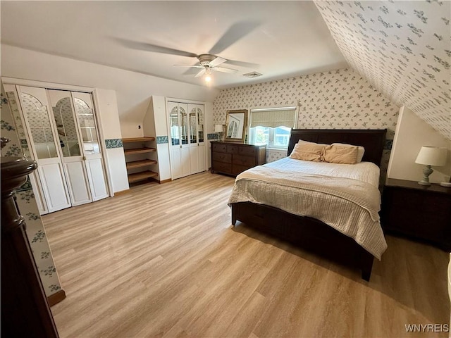 80 Fredro St, Buffalo, NY 14206 - bedroom with light wood finished floors, wallpapered walls, two closets, and ceiling fan