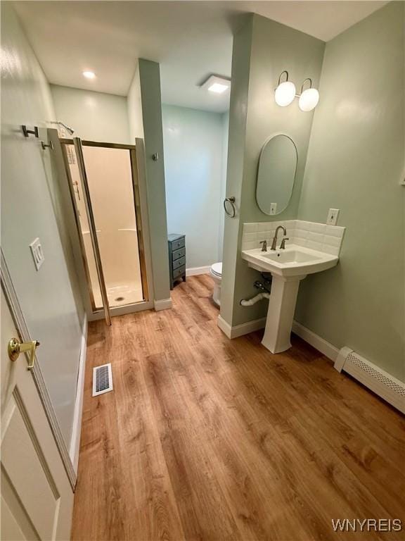 80 Fredro St, Buffalo, NY 14206 - bathroom featuring wood finished floors, a shower stall, and a baseboard radiator