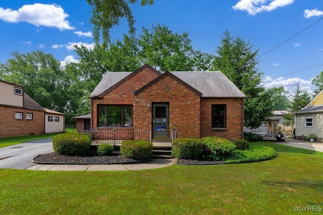 473 Seneca Creek Rd, West Seneca, NY 14224 - english style home featuring brick siding, a front yard, and roof with shingles