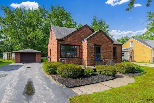 473 Seneca Creek Rd, West Seneca, NY 14224 - view of front of home featuring brick siding, an outbuilding, a garage, a shingled roof, and driveway