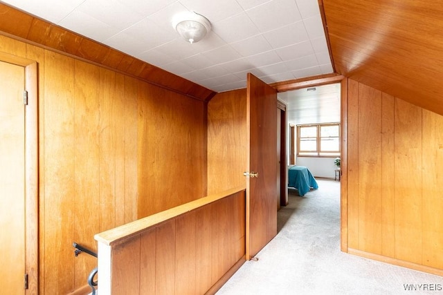 473 Seneca Creek Rd, West Seneca, NY 14224 - hallway with lofted ceiling, light carpet, and wood walls
