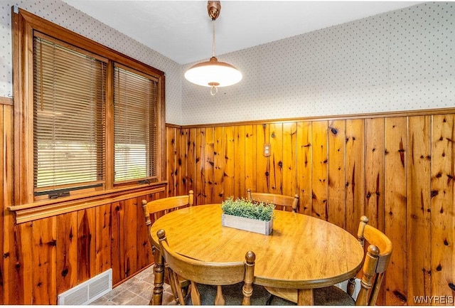 473 Seneca Creek Rd, West Seneca, NY 14224 - dining space with wallpapered walls, wooden walls, and a wainscoted wall