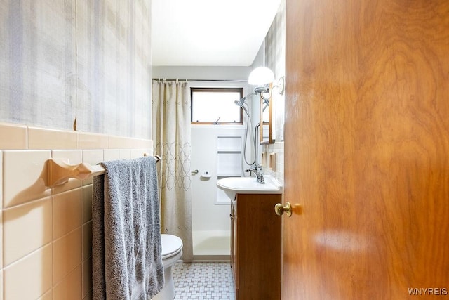 473 Seneca Creek Rd, West Seneca, NY 14224 - full bath with a shower with shower curtain, vanity, tile patterned floors, and tile walls