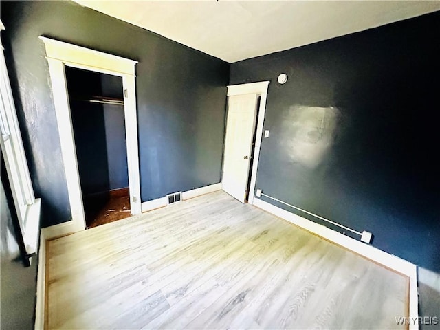 67 Holmes St, Buffalo, NY 14207 - unfurnished bedroom with wood finished floors and a closet