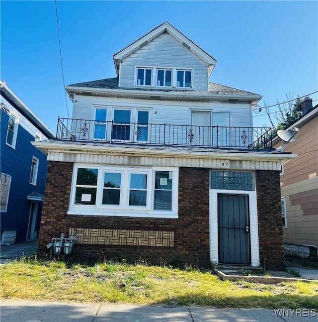 67 Holmes St, Buffalo, NY 14207 - american foursquare style home featuring a balcony and brick siding