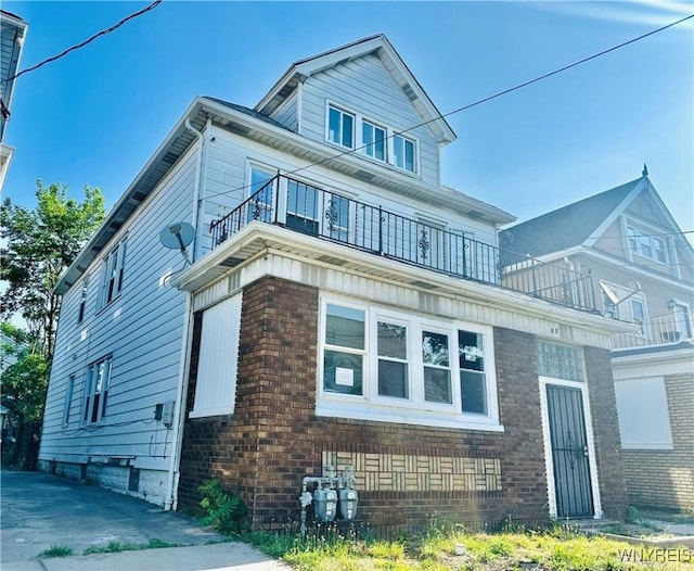 67 Holmes St, Buffalo, NY 14207 - view of side of property with a balcony and brick siding