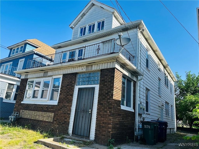 67 Holmes St, Buffalo, NY 14207 - view of front of house with a balcony and brick siding