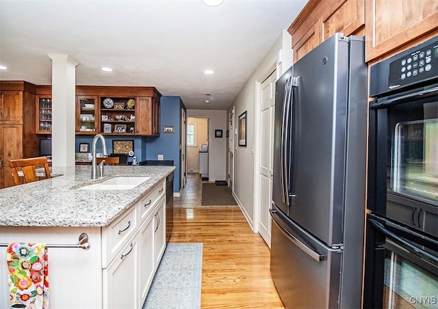 101 Luan Cir, Dewitt, NY 13078 - kitchen with freestanding refrigerator, light wood-type flooring, light stone countertops, recessed lighting, and white cabinets