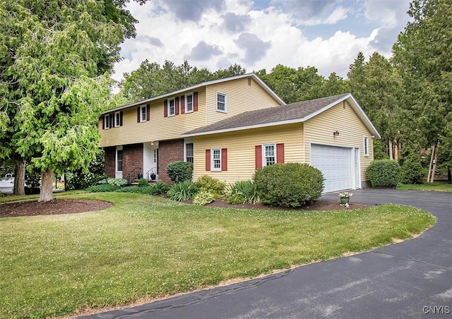 101 Luan Cir, Dewitt, NY 13078 - view of front of house with asphalt driveway, a front yard, and an attached garage