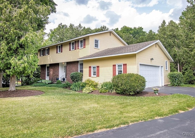 101 Luan Cir, Dewitt, NY 13078 - colonial inspired home featuring a front yard, asphalt driveway, an attached garage, and brick siding
