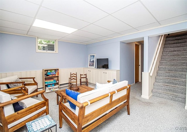 101 Luan Cir, Dewitt, NY 13078 - carpeted living area with a paneled ceiling, stairs, and a wainscoted wall