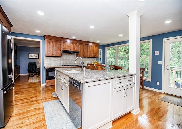 101 Luan Cir, Dewitt, NY 13078 - kitchen with black appliances, under cabinet range hood, light wood finished floors, decorative backsplash, and recessed lighting
