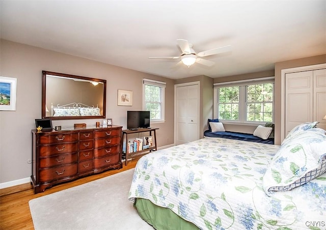 101 Luan Cir, Dewitt, NY 13078 - bedroom featuring multiple closets, multiple windows, wood finished floors, and ceiling fan