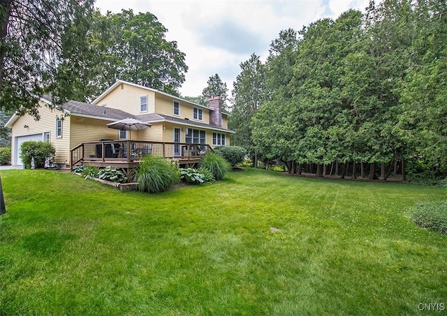 101 Luan Cir, Dewitt, NY 13078 - rear view of house with a deck, a lawn, a garage, and a chimney