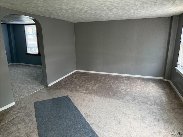 231 N Main St, Oneida, NY 13421 - spare room featuring arched walkways and carpet flooring