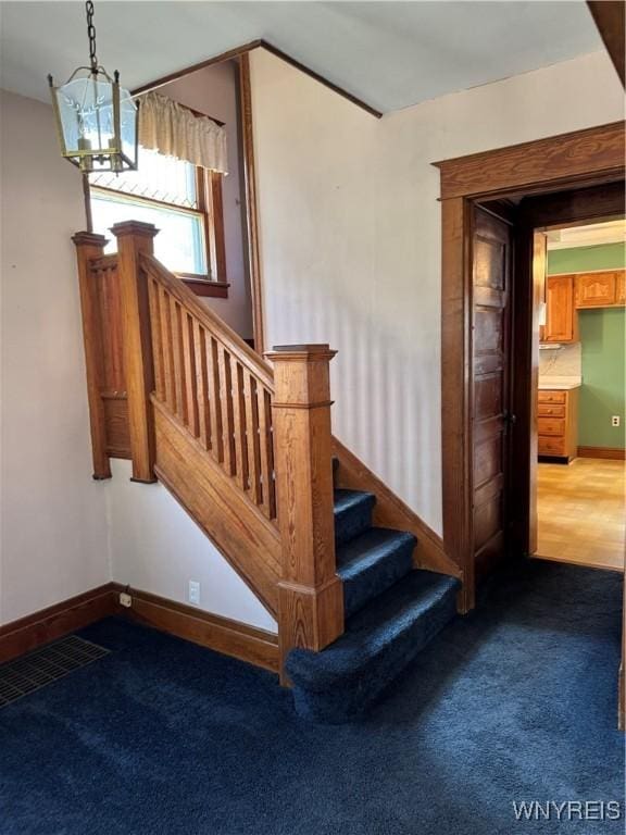 45 Clio Ave, Buffalo, NY 14220 - staircase with carpet floors and a chandelier