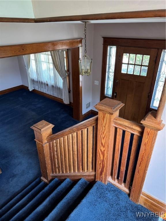 45 Clio Ave, Buffalo, NY 14220 - carpeted foyer entrance featuring stairway and a chandelier