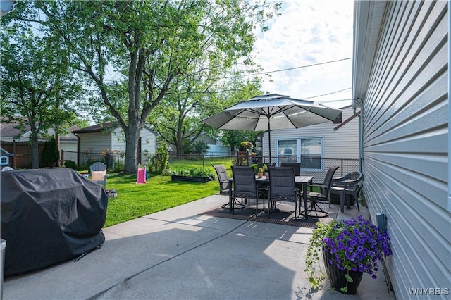 282 N Wrexham Ct, Tonawanda, NY 14150 - fenced backyard featuring area for grilling, outdoor dining area, and a patio