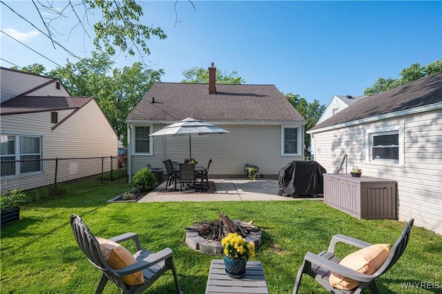 282 N Wrexham Ct, Tonawanda, NY 14150 - back of property with a chimney, a patio area, and a fire pit
