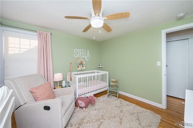 282 N Wrexham Ct, Tonawanda, NY 14150 - bedroom with wood finished floors, a crib, and ceiling fan