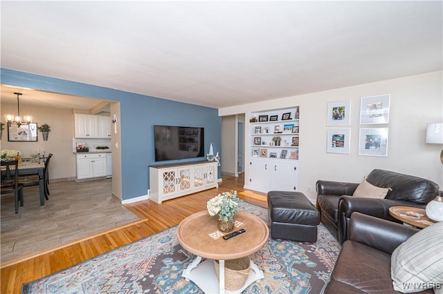 282 N Wrexham Ct, Tonawanda, NY 14150 - living area featuring a chandelier, light wood-style floors, and built in features