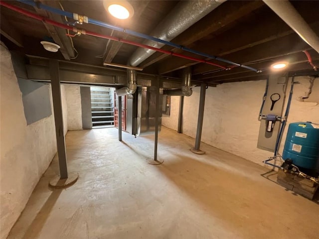 1574 Pine St, Woodhull, NY 14898 - unfinished below grade area featuring a water pressure tank, stairs, and electric panel