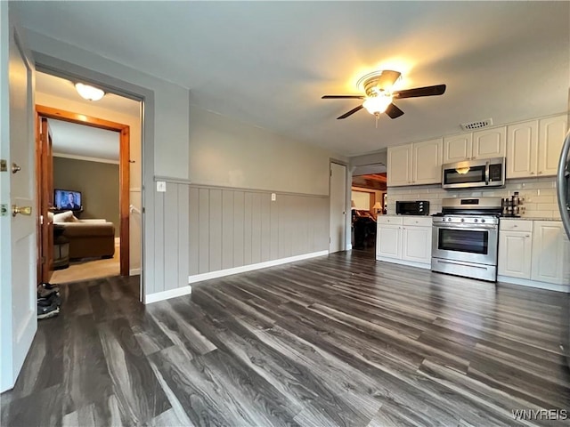 60 Waltham Ave, Lancaster, NY 14086 - kitchen featuring stainless steel appliances, a ceiling fan, white cabinets, dark wood-style floors, and a wainscoted wall