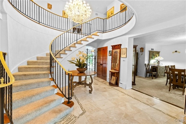 5 Hingham Rd, Utica, NY 13501 - stairs with a chandelier and marble look tile flooring