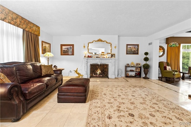5 Hingham Rd, Utica, NY 13501 - living room with a textured ceiling and a lit fireplace