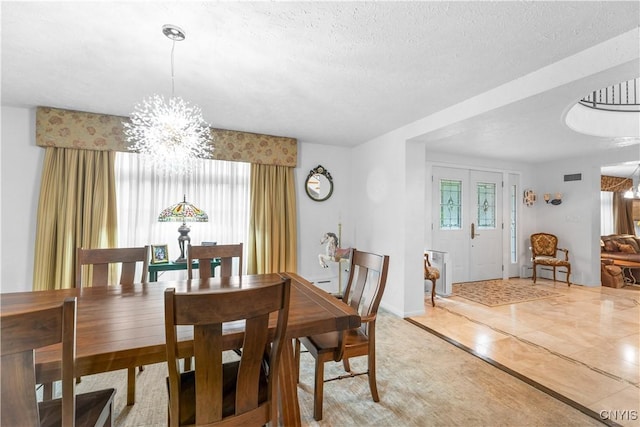 5 Hingham Rd, Utica, NY 13501 - dining area featuring a chandelier, a baseboard radiator, and a textured ceiling