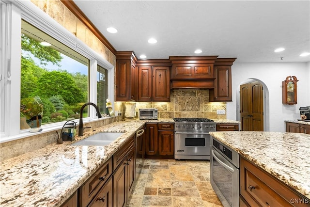 5 Hingham Rd, Utica, NY 13501 - kitchen featuring appliances with stainless steel finishes, tasteful backsplash, light stone finish flooring, recessed lighting, and light stone countertops