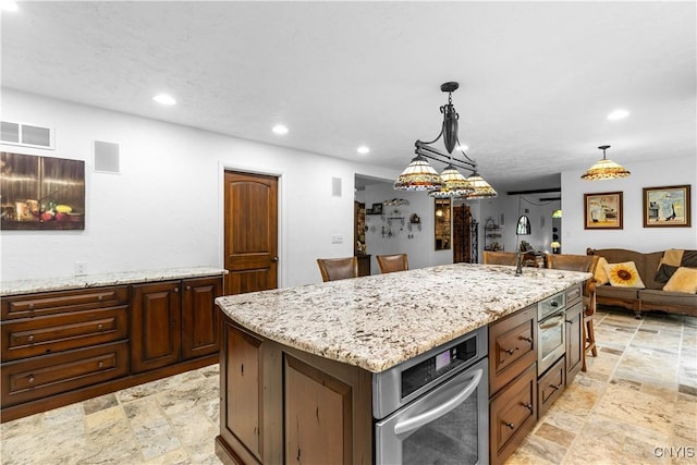 5 Hingham Rd, Utica, NY 13501 - kitchen with stone tile flooring, recessed lighting, light stone countertops, and hanging light fixtures