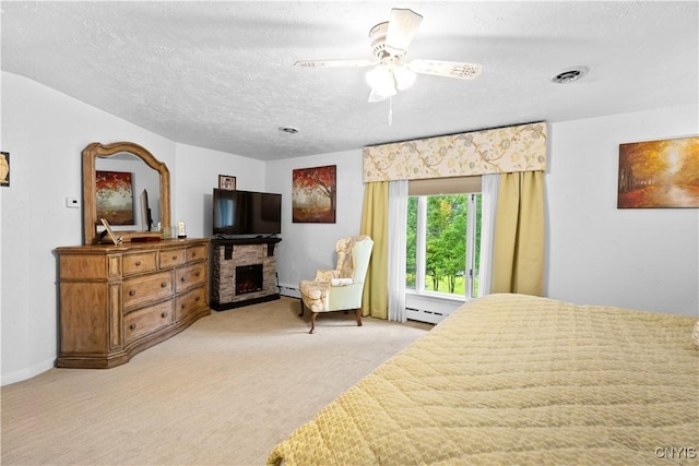 5 Hingham Rd, Utica, NY 13501 - bedroom featuring a baseboard heating unit, a stone fireplace, light carpet, and a textured ceiling